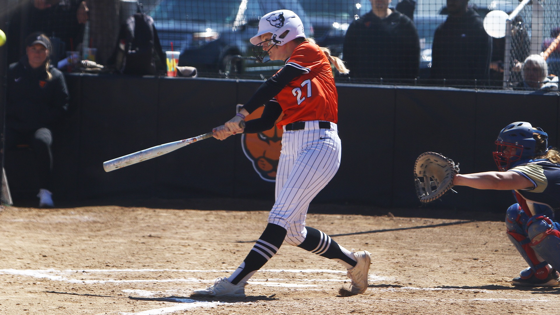 Kelsey Martlage in orange jersey hitting ball