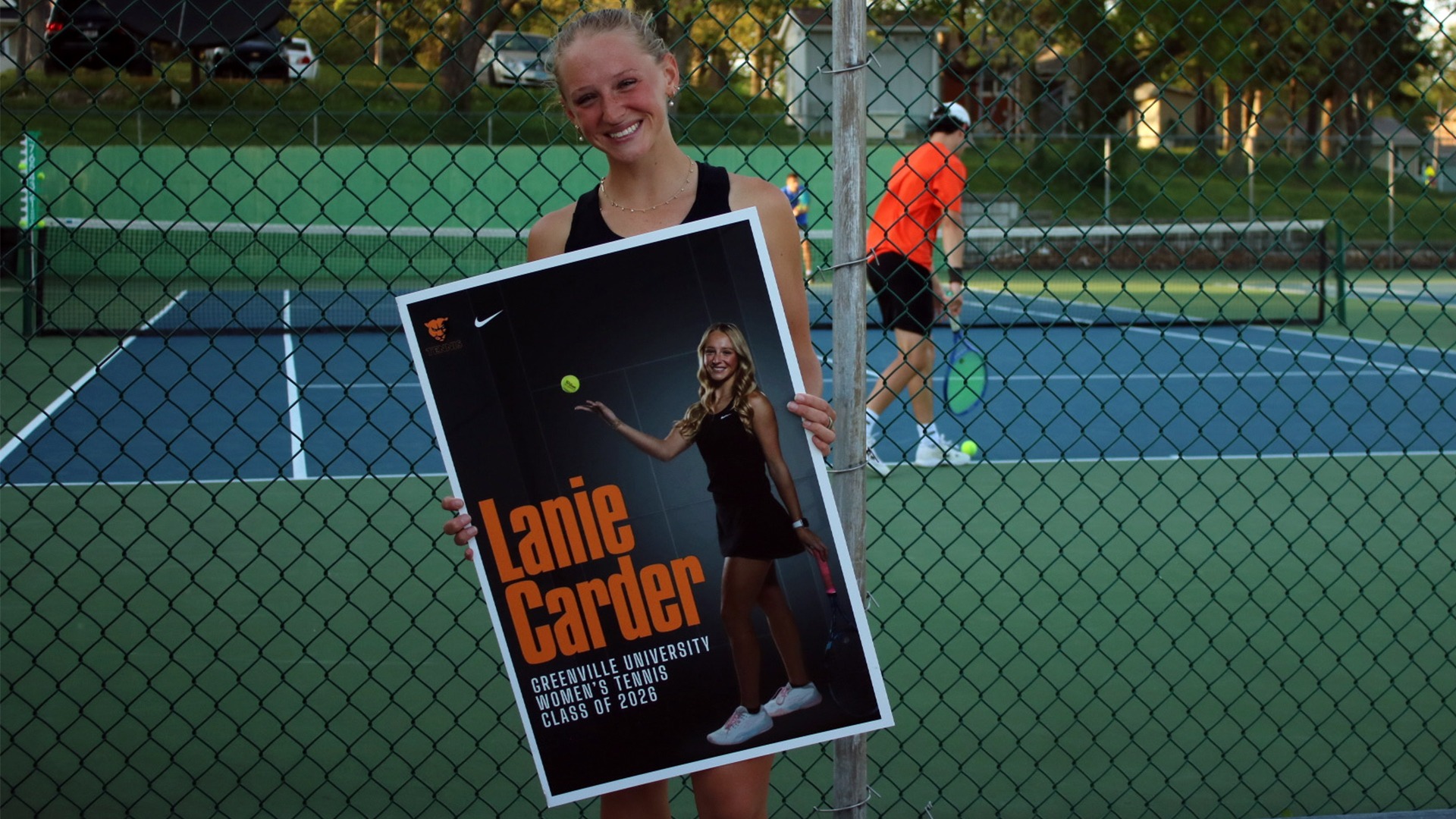 Lanie Carder holding up senior day poster
