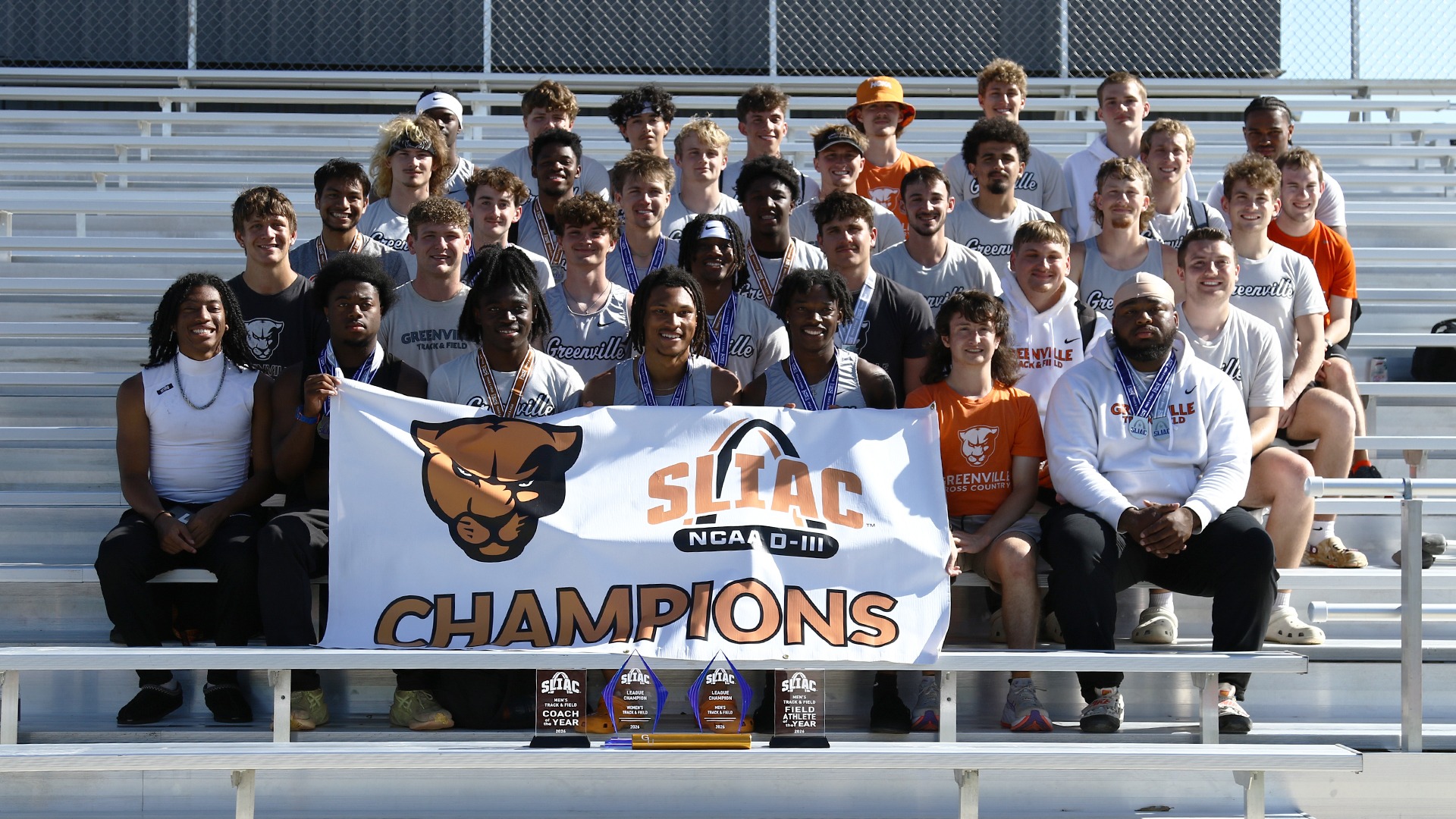 team picture of them holding champ banner after winning SLIAC