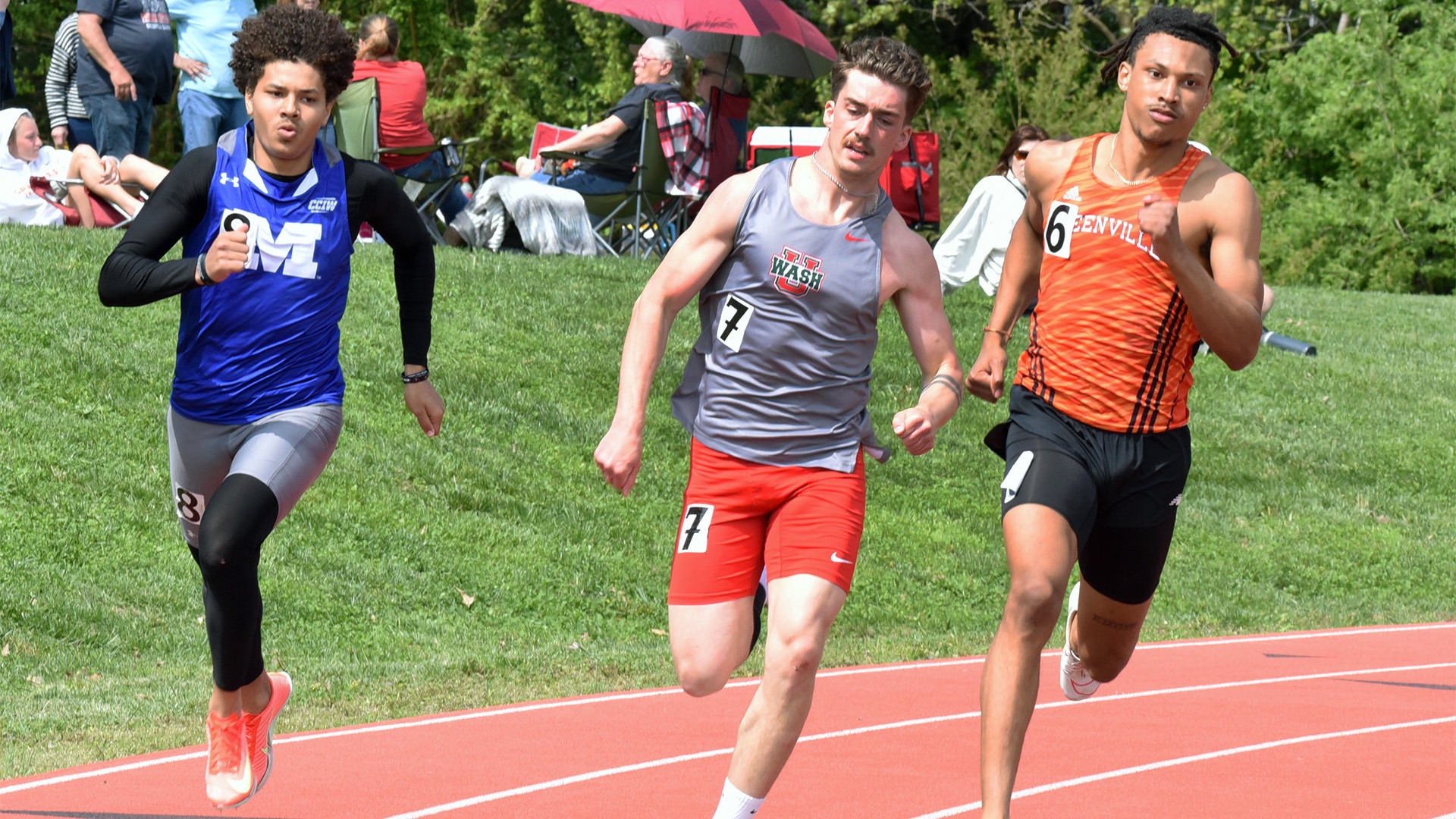 Noel Andino in orange uniform racing on track 