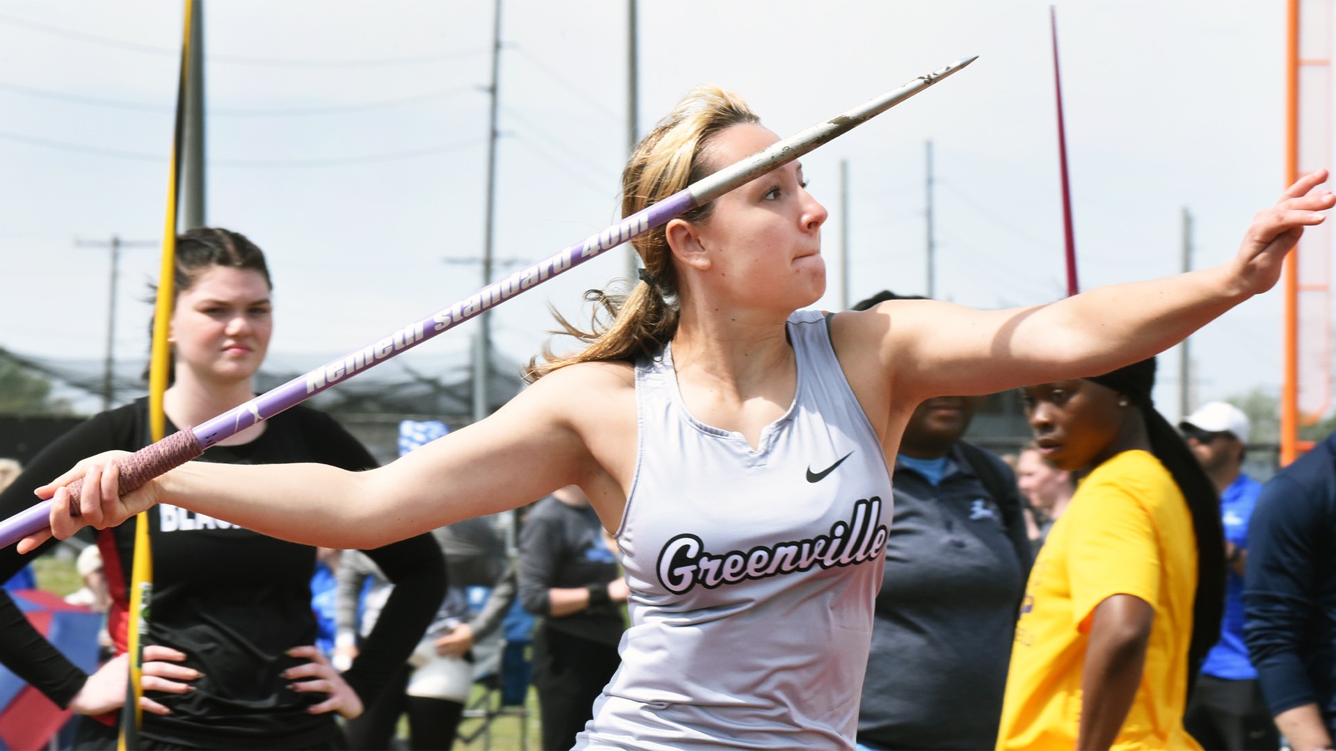 Yunck in grey uniform throwing javelin