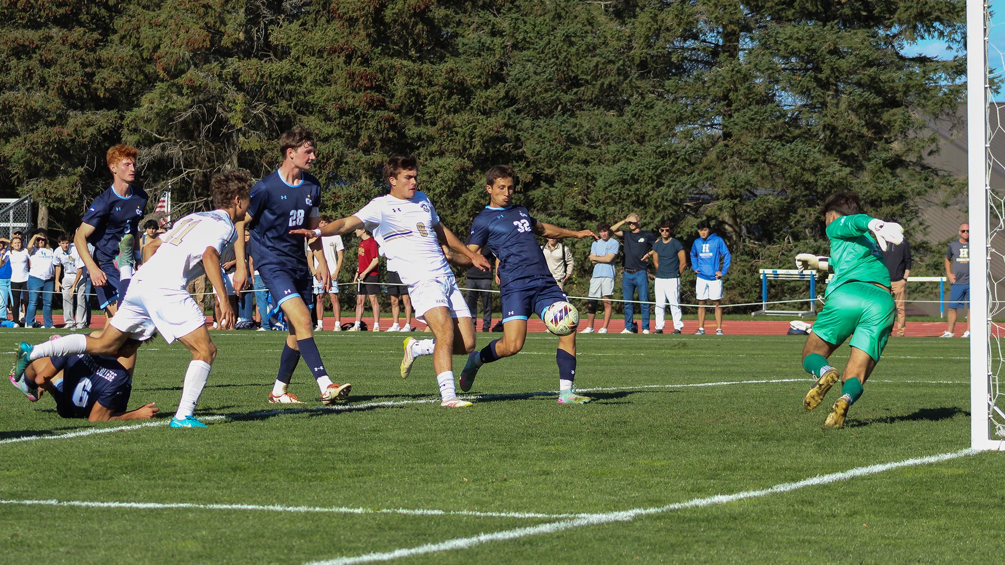 Men's soccer players from Hamilton and Connecticut College fight for possession in the 6-yard box in October 2025