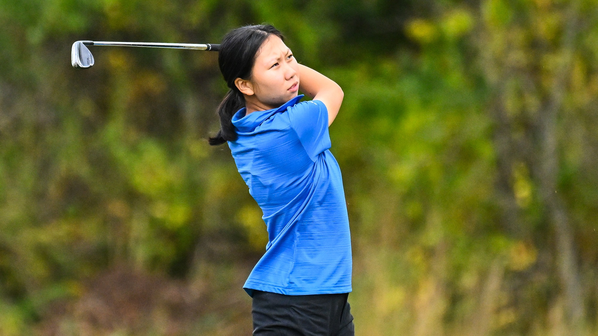Hellen Xiang watches her iron shot on the driving range during practice in September 2025