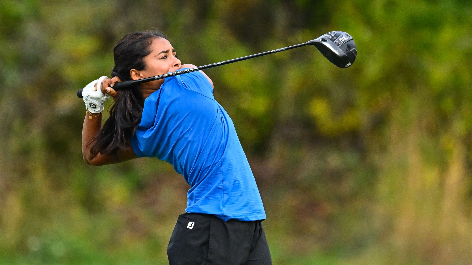 Shanya Arasu hits driver on the driving range during golf practice in September 2025