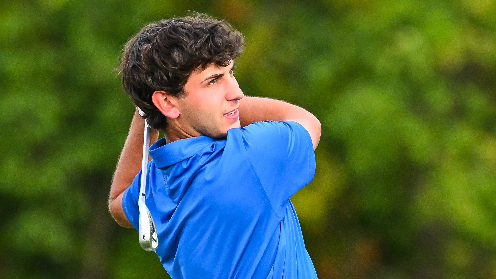 Jake Hendelman watches his shot with an 8-iron on the practice range in September 2025