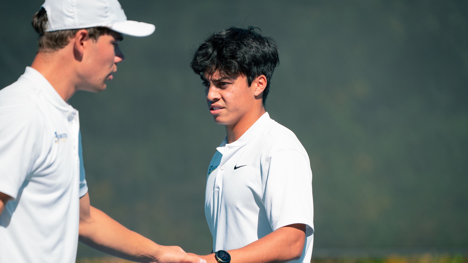 Men's Tennis players Villem Aadamsoo and Lleyton Mendieta congratulate each other after a point at the ITA Cup