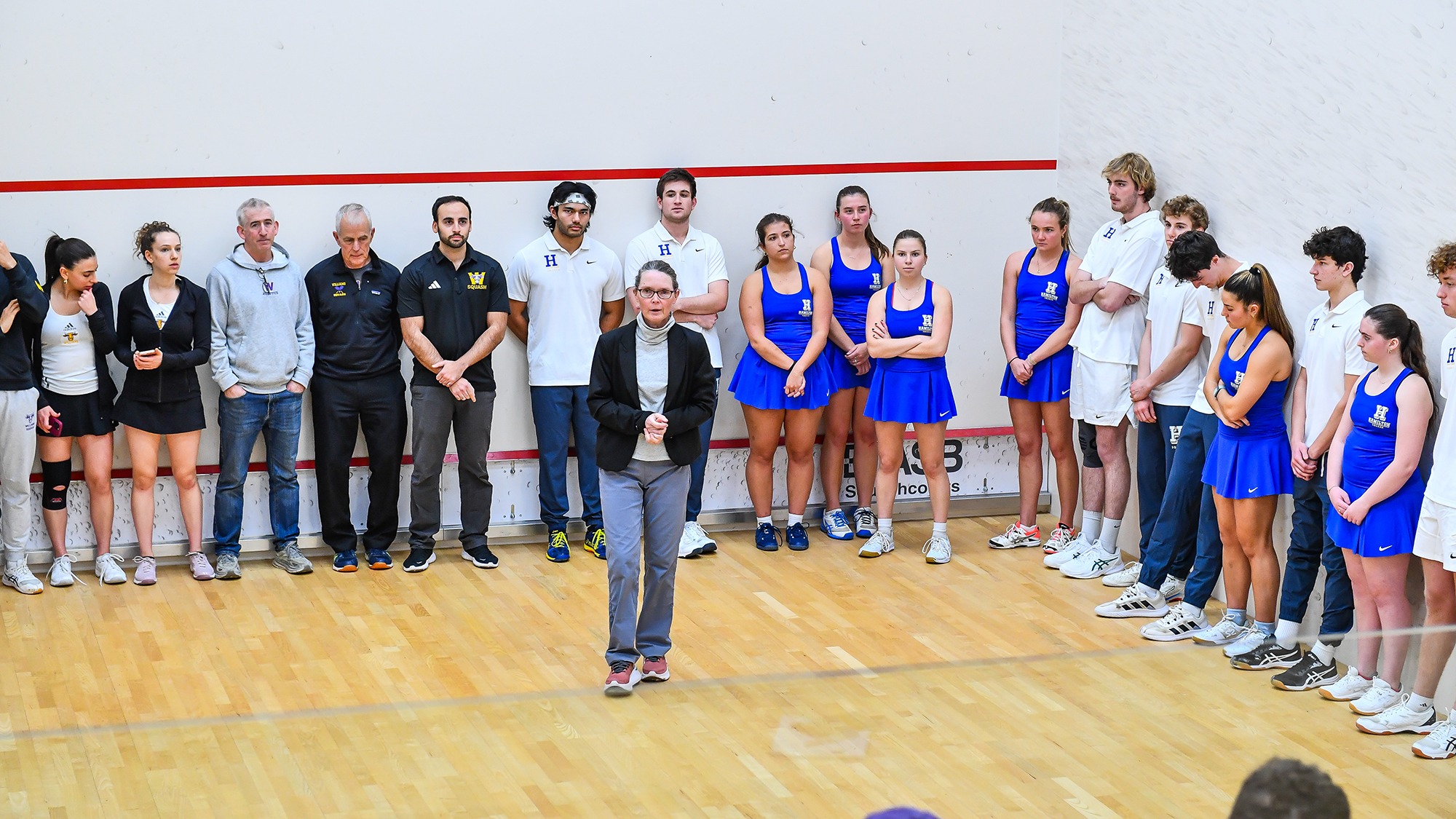 Squash teams prepare for lineup introductions prior to the match against Williams in November 2024