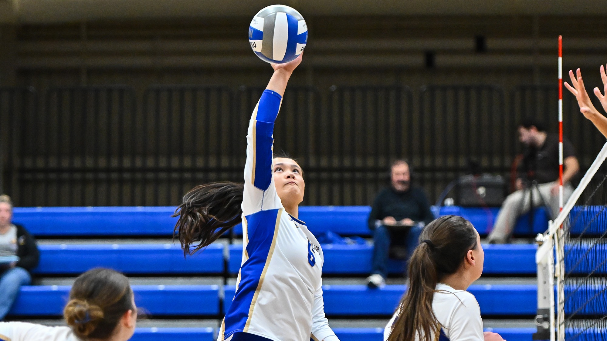 Grace Seaman jumps up to spike the ball against Wesleyan in October 2025