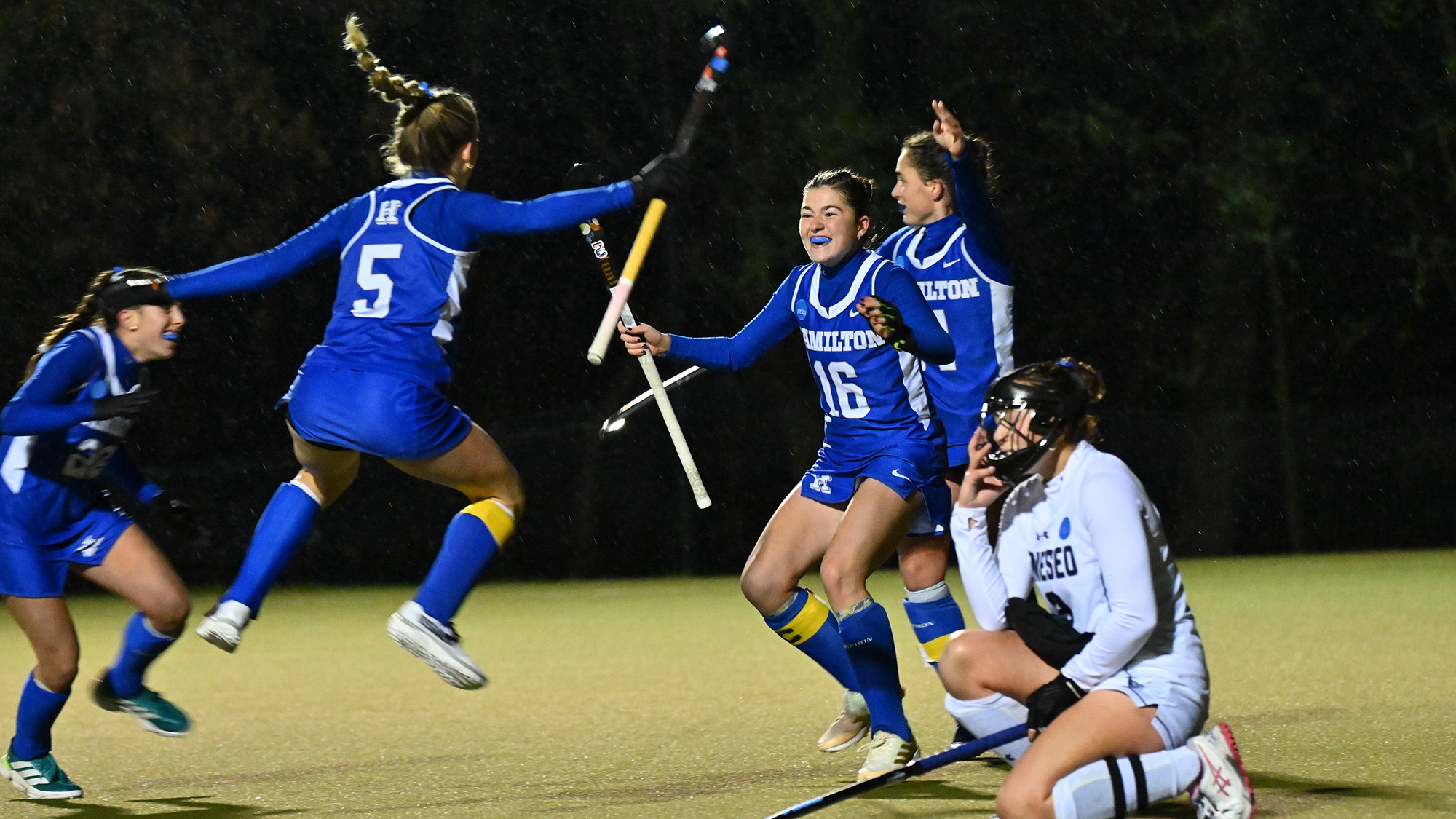 Field hockey players celebrate the game-winning goal against SUNY Geneseo in the 2025 NCAA Championship first round