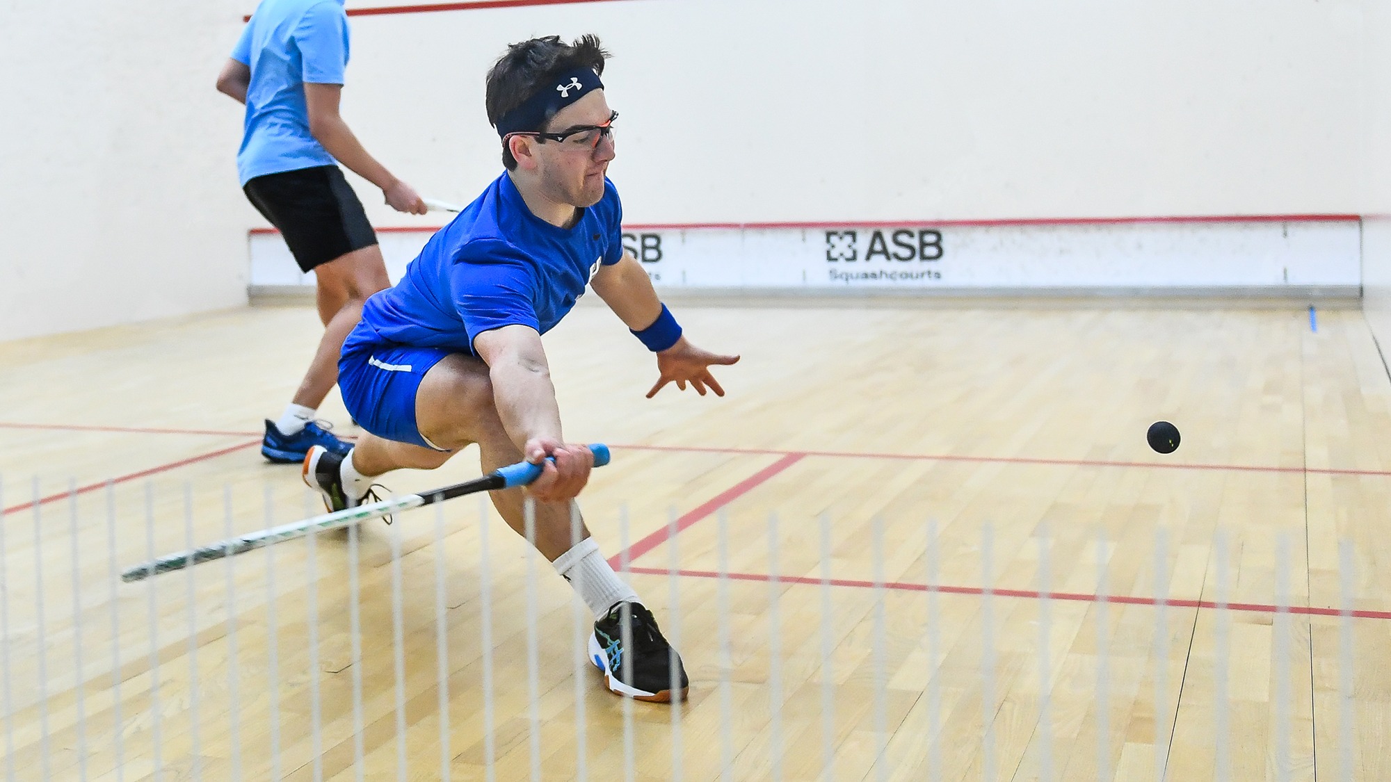 Jacob Shulman reaches to return the squash ball against Conn. College in January 2025