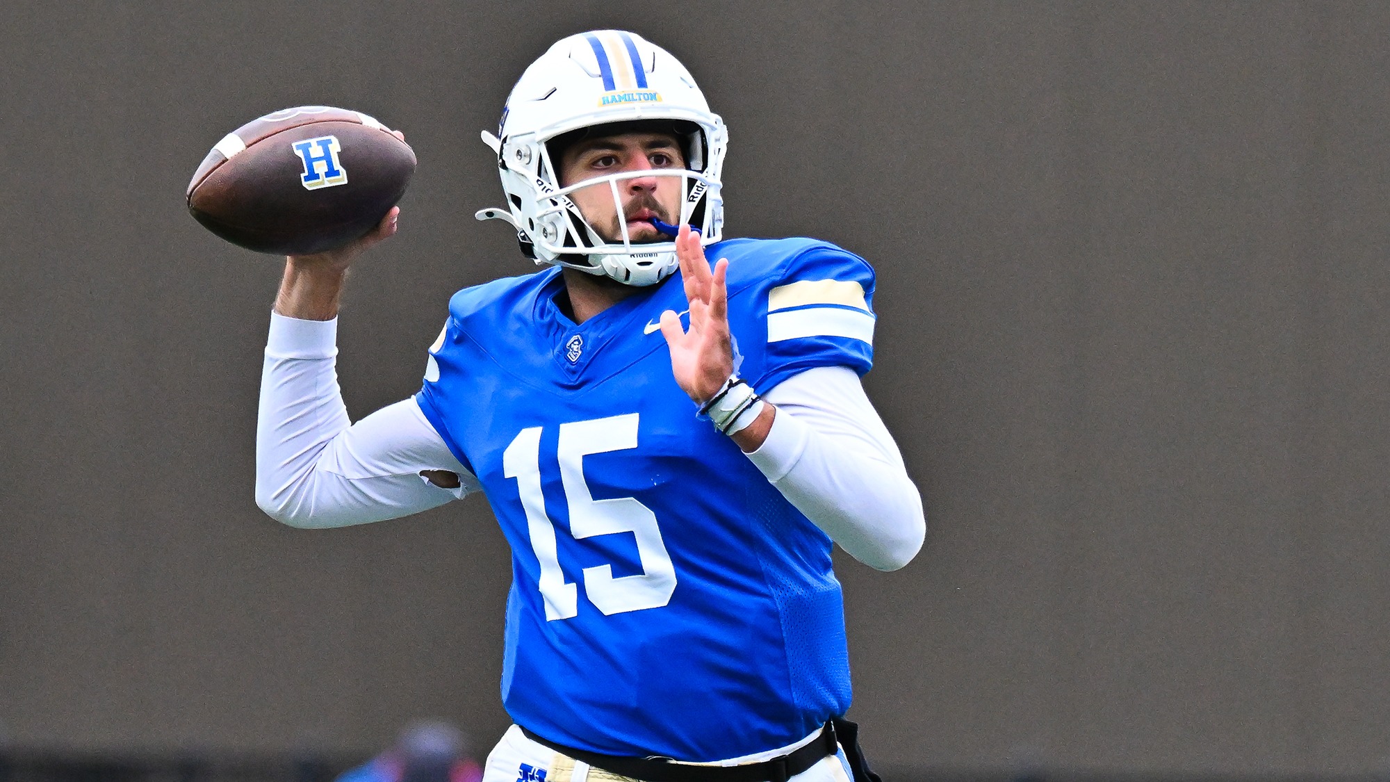 Luke Kurzum gets ready to throw to a receiver downfield against Middlebury in November 2025