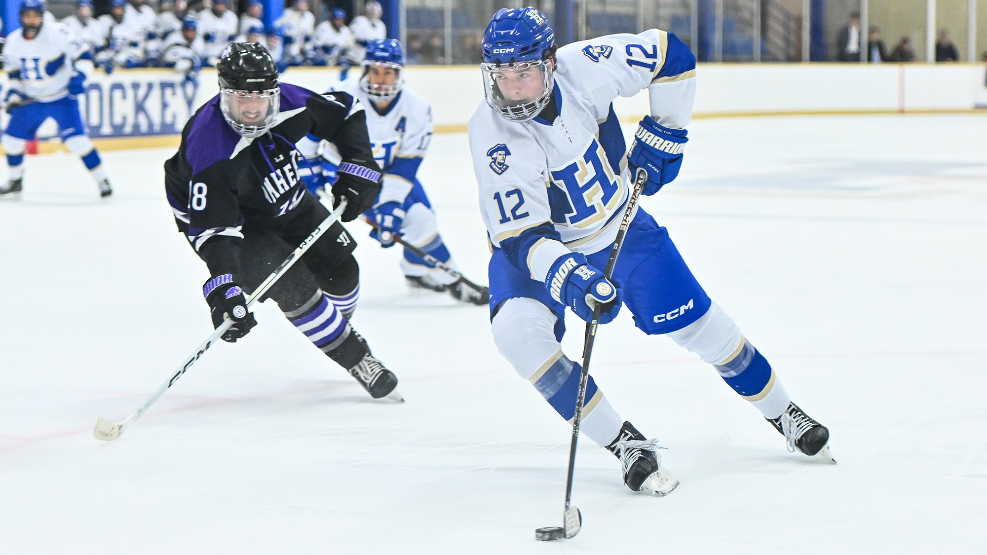 Clarence Beltz puts the puck on his backhand and drives towards the net against Amherst