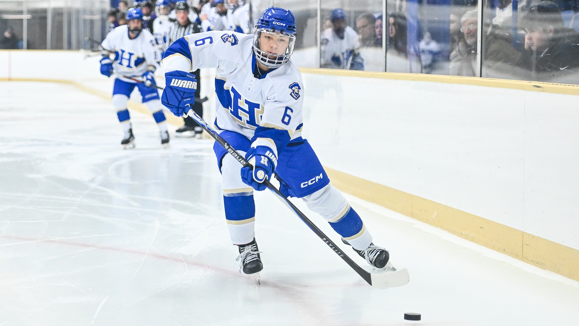 Ryan Sordillo passes the puck around the boards against Amherst in November 2025
