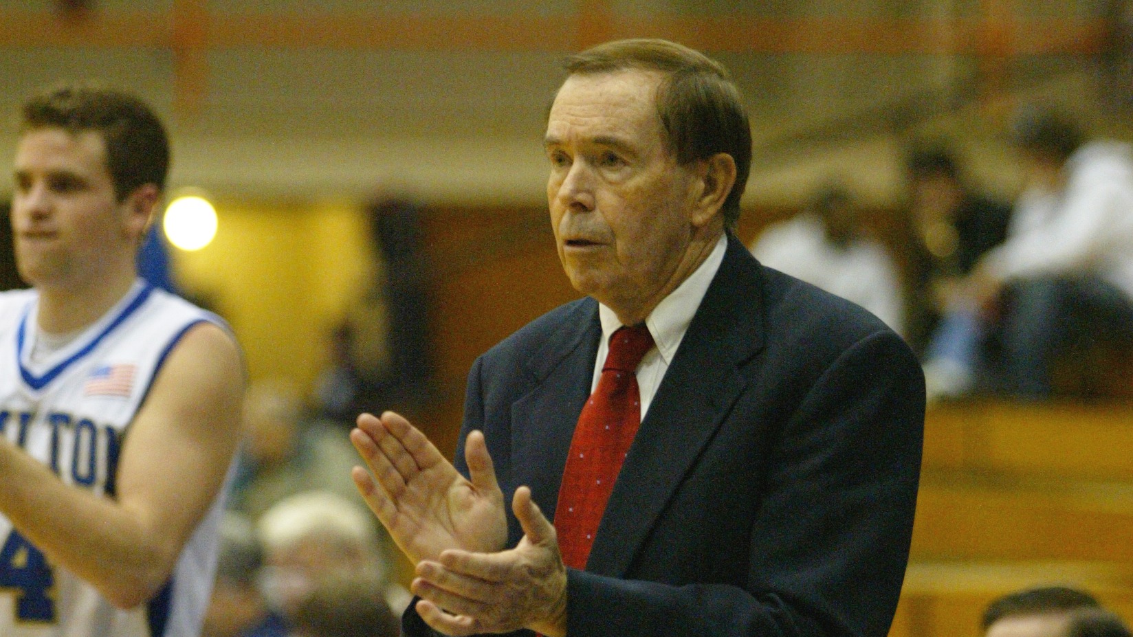 Tom Murphy stands and claps on the sideline during a men's basketball game in January 2004