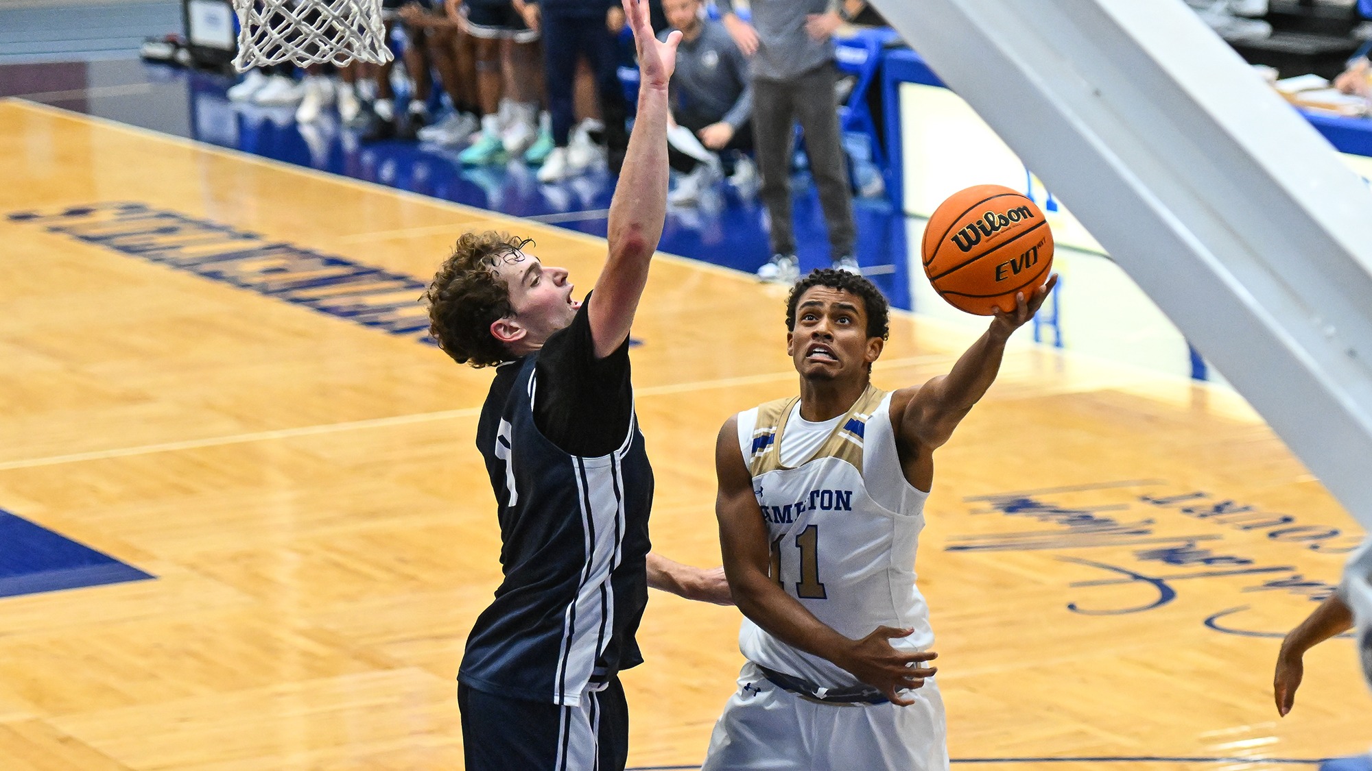 Matthew Rideout puts the ball up for a layup against Ithaca in November 2025