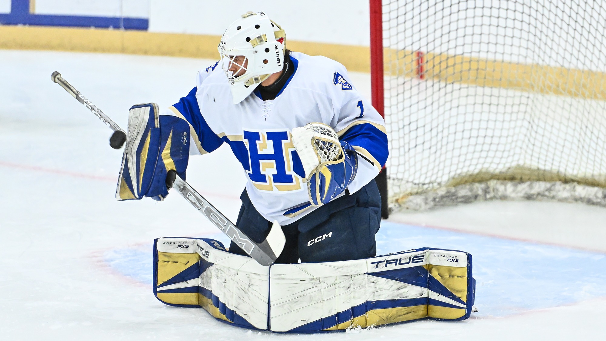Aksel Reid stops the puck with his blocker during warmups before the Amherst game in November 2025