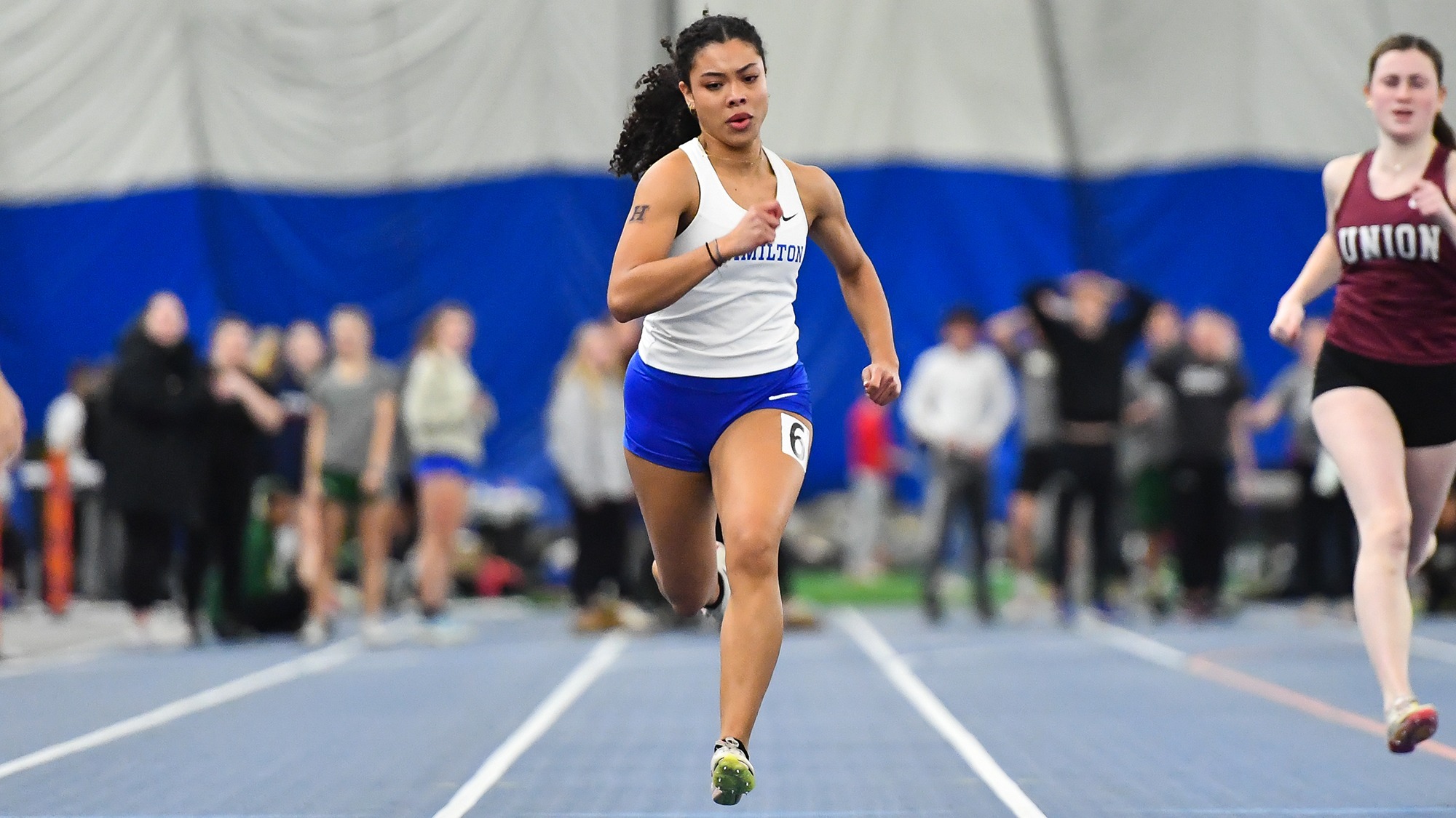 Tatiana McCray sprints down the straightaway in the 60 meters at Utica in January 2025