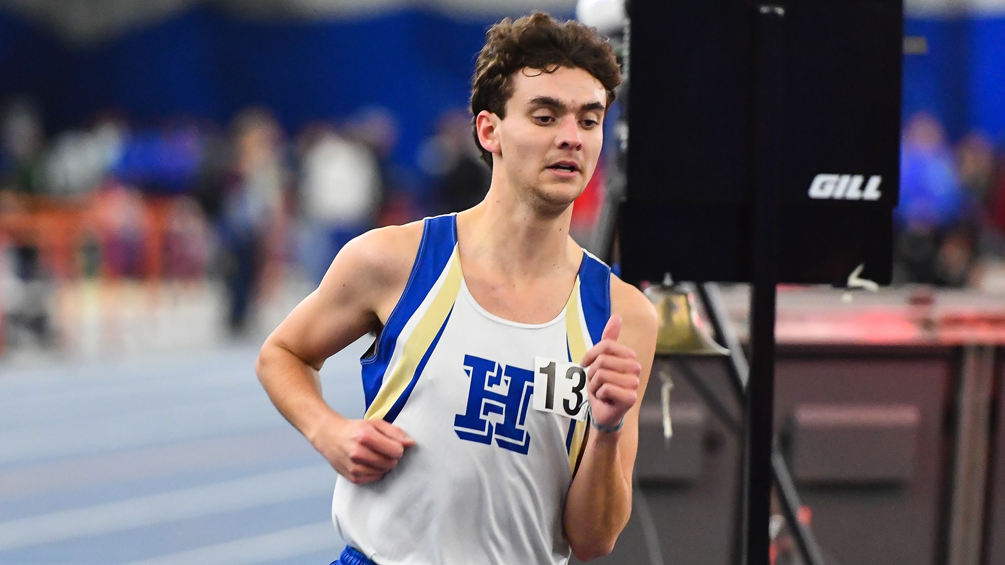 Liam Card runs in the 3,000 meters at an indoor meet at Utica in January 2025