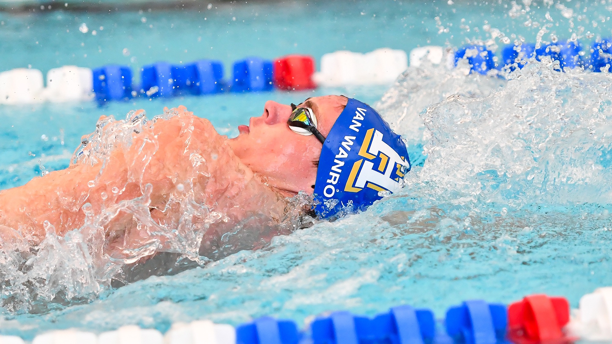 Sebastian van Wanroy '26 does the backstroke during swim practice in January 2025