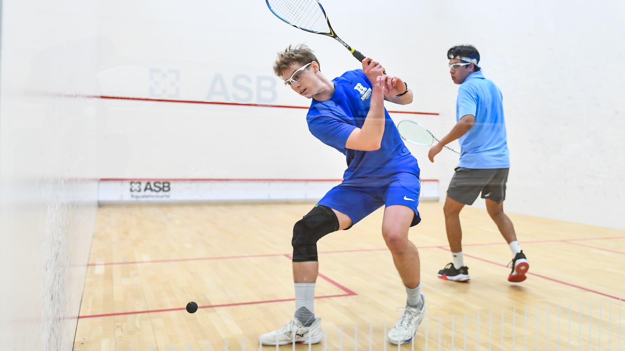 Joseph Applebaum winds up for a backhand return against Conn. College in January 2025