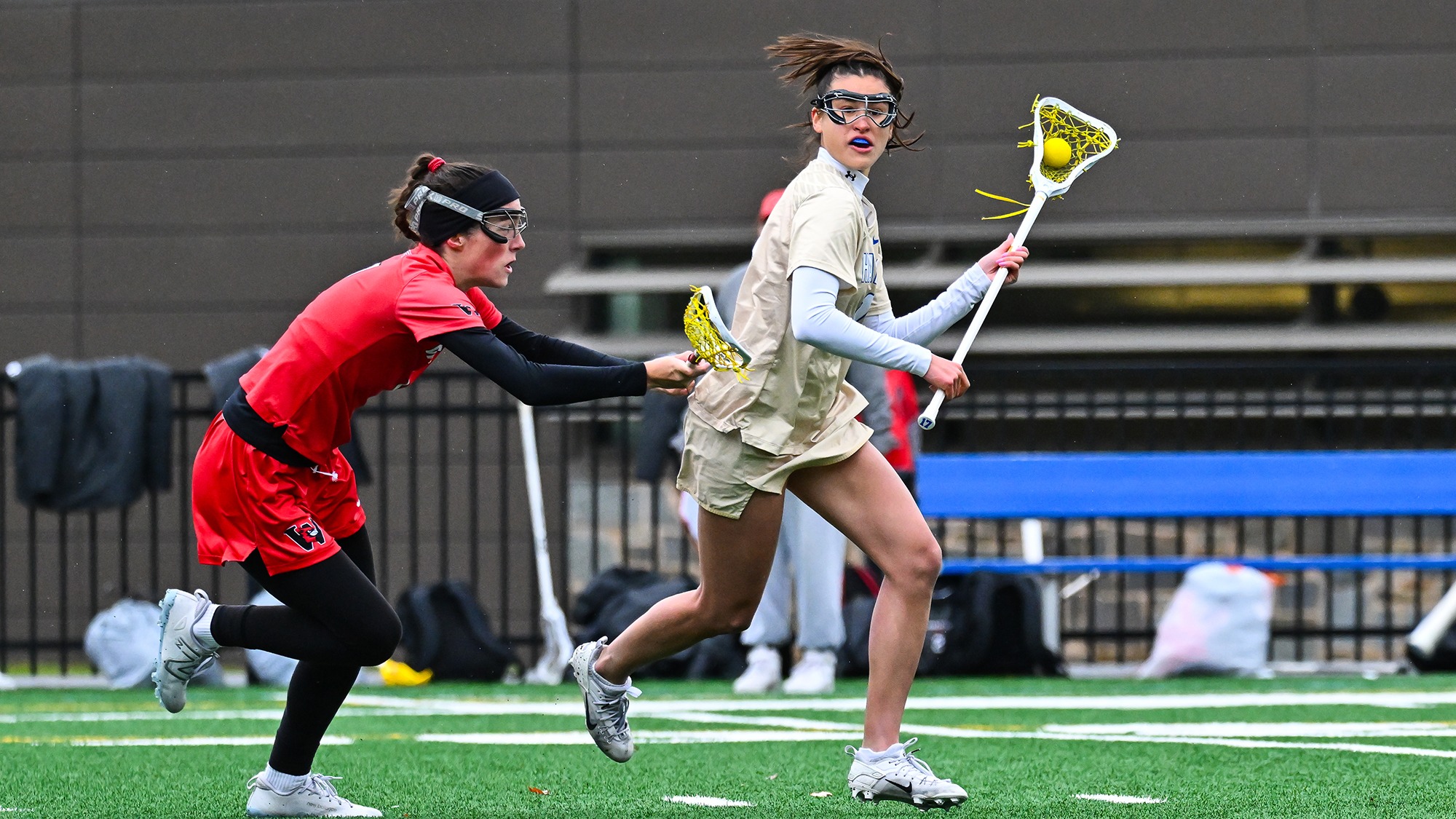 Leyna Schlaefer looks for a women's lacrosse teammate to pass to against Wesleyan in April 2025