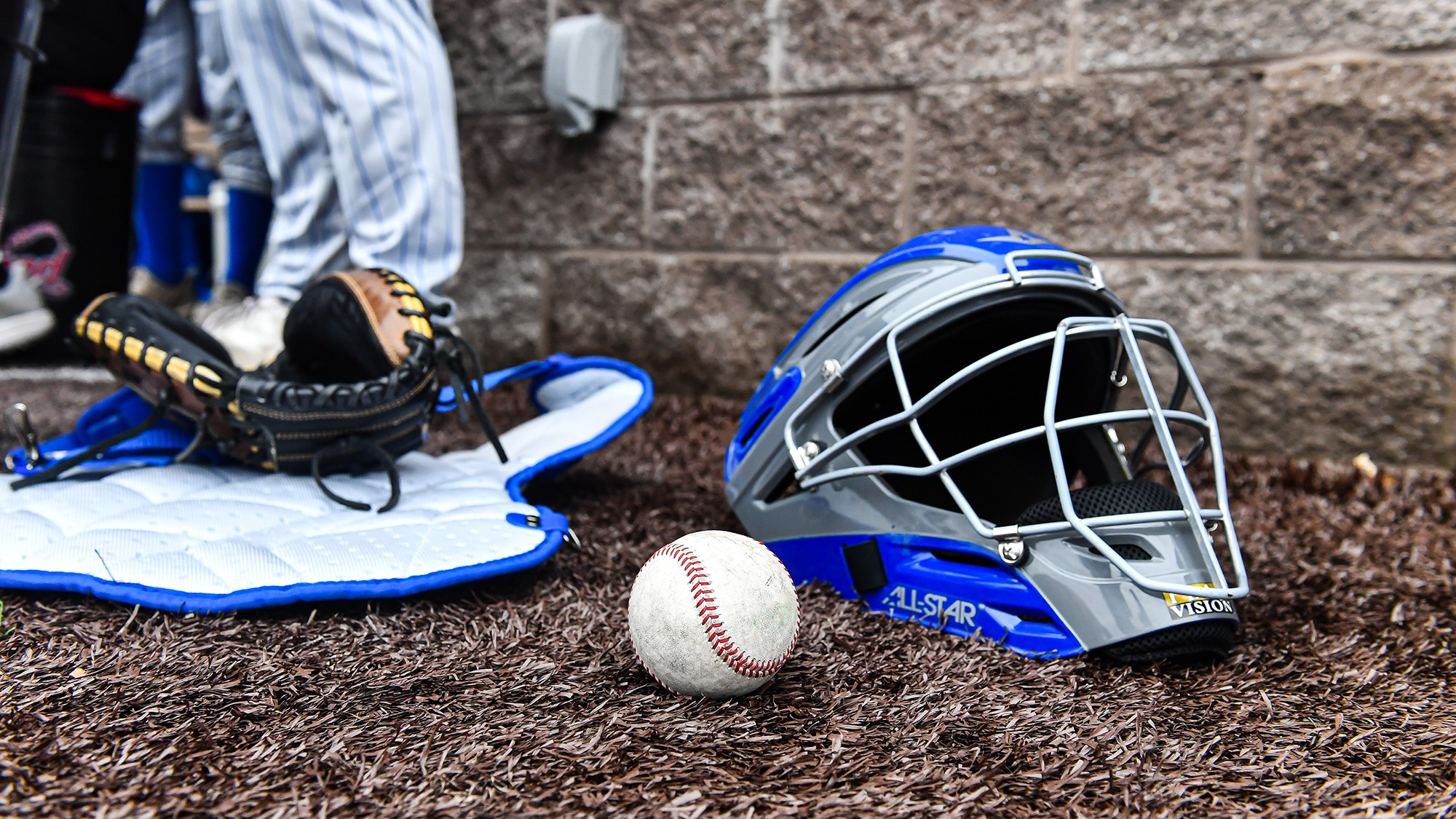 Baseball catcher's equipment and ball sitting on the turf before the Williams game in April 2025