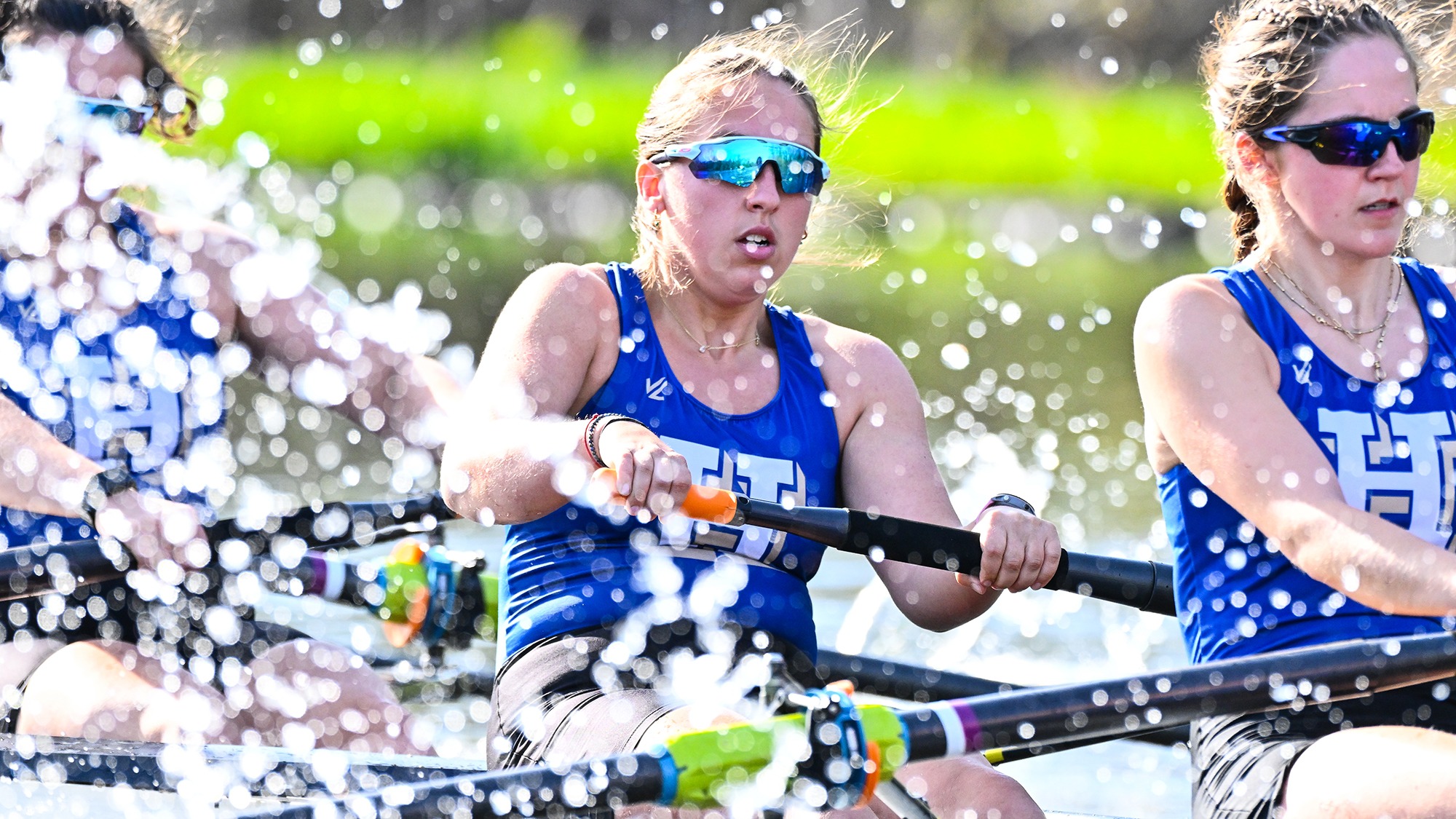 Water splashes around Annika Benn as she rows during practice on the Erie Canal in April 2025