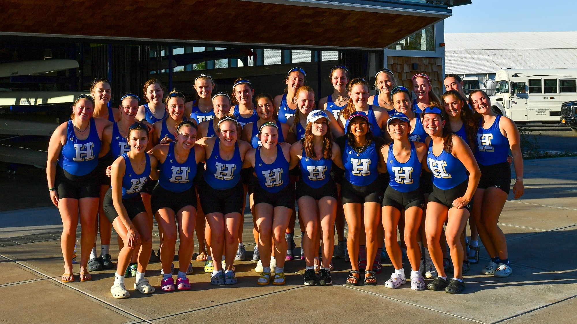 Women's Rowing 2025 team photo taken in front of boathouse in Rome