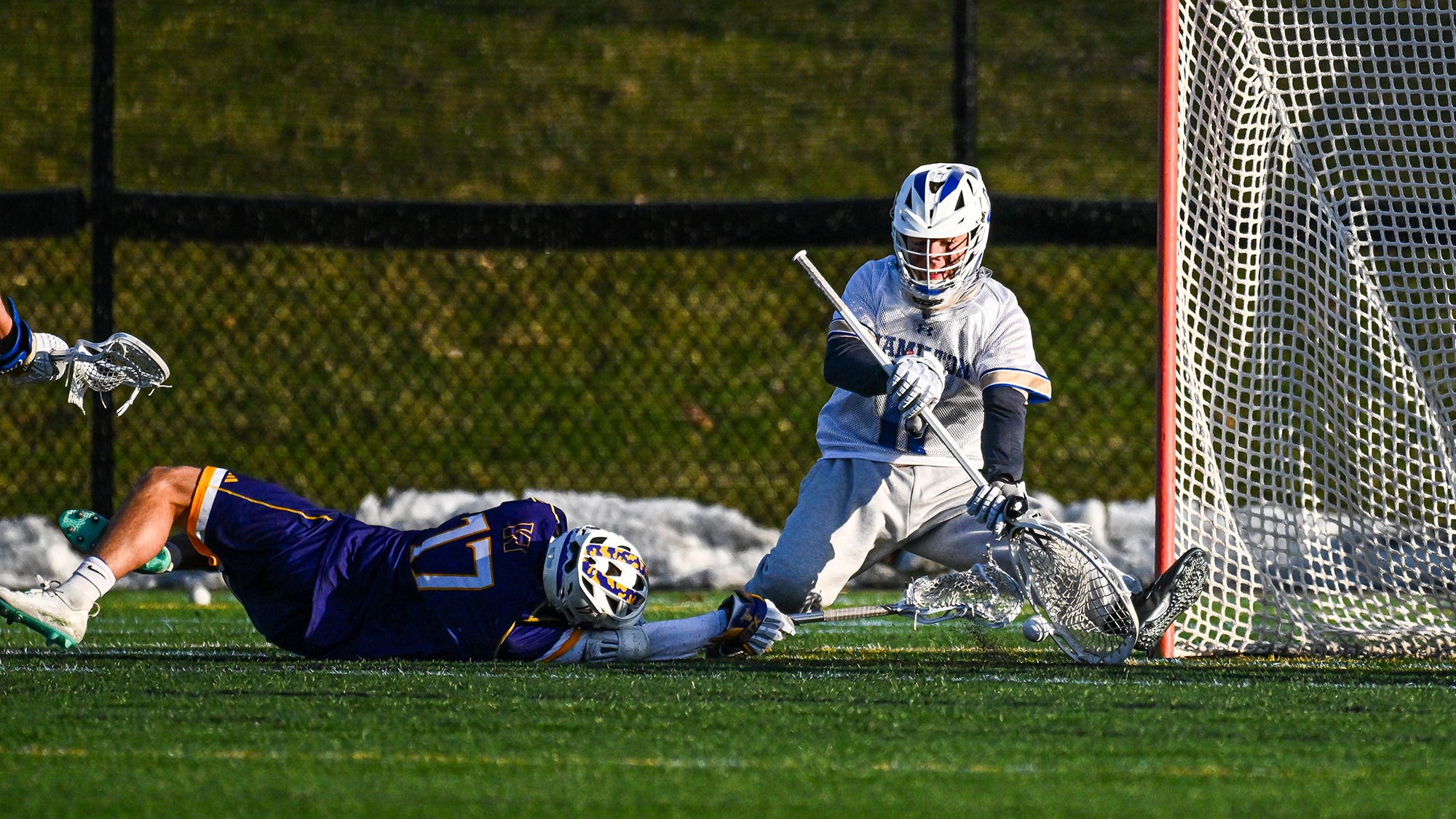 Goalie Jack Fried goes down to one knee to make a save against Williams in April 2025