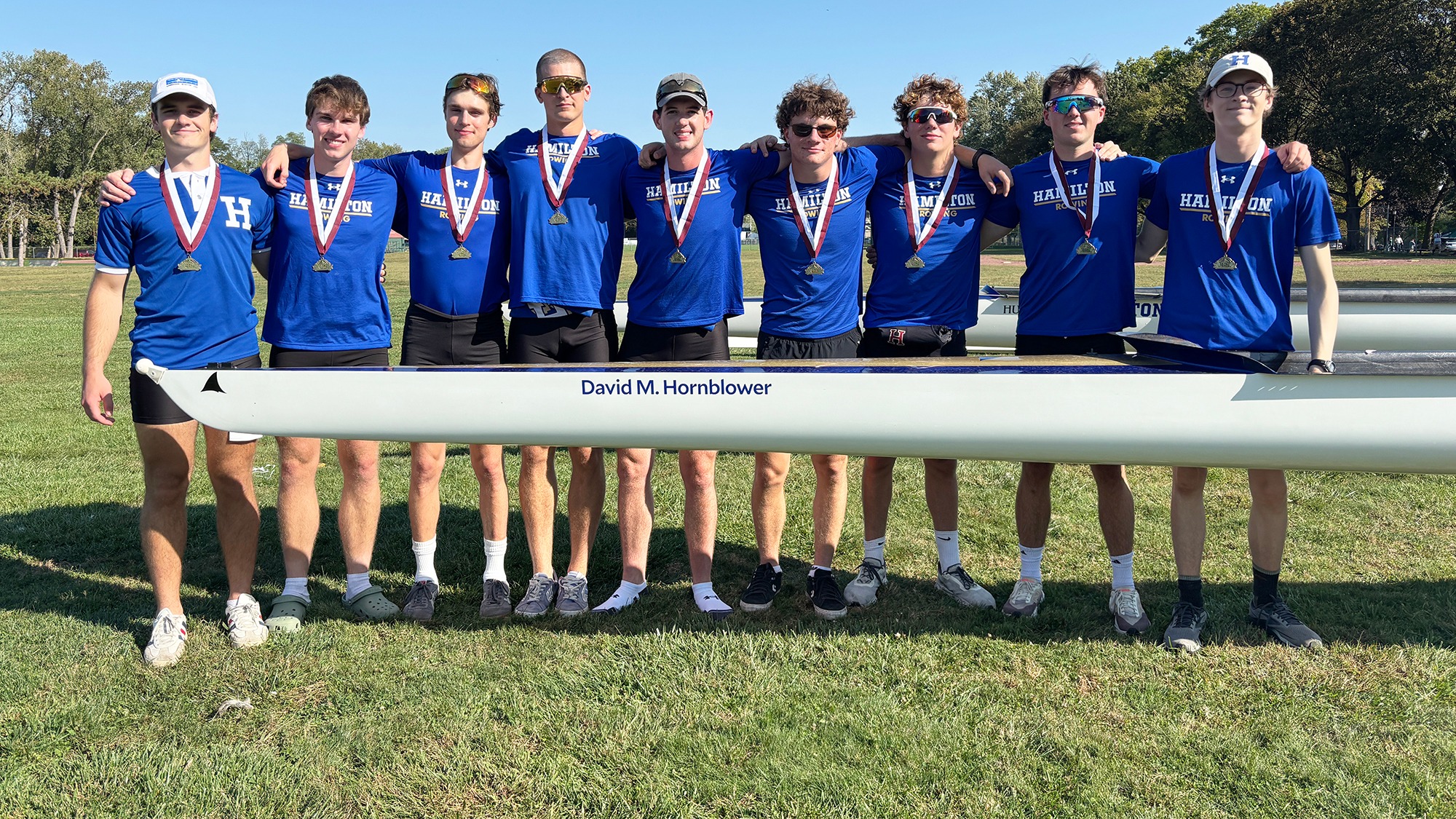 Members of the Men's Rowing team pose with their gold medals after the 2025 Mohawk Fall Classic Regatta