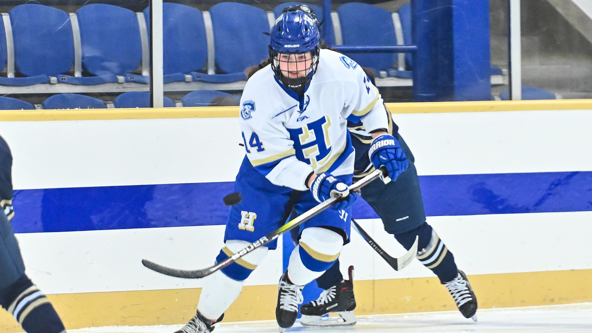 Bri Rockwood tries to knock down the puck out of midair with her hockey stick against SUNY Canton