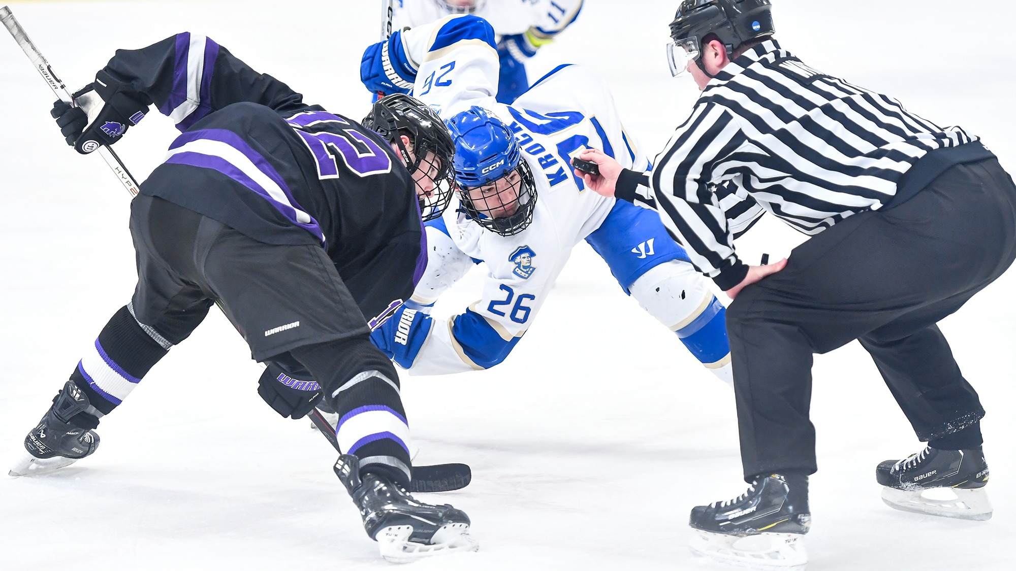 Jackson Krock waits for the linesman to drop the puck for a faceoff against Amherst