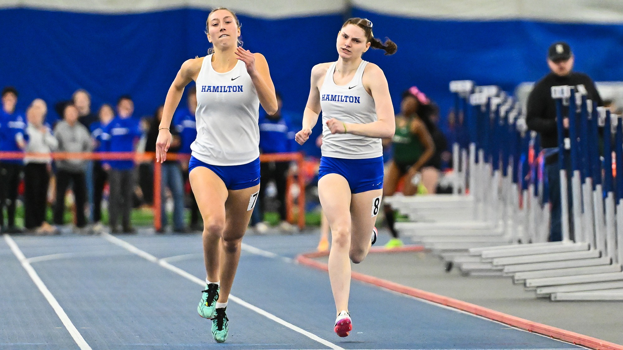 Hannah Turner and Mia O'Neill come down the homestretch in the 400 meters at the 2026 Utica Winter Opener
