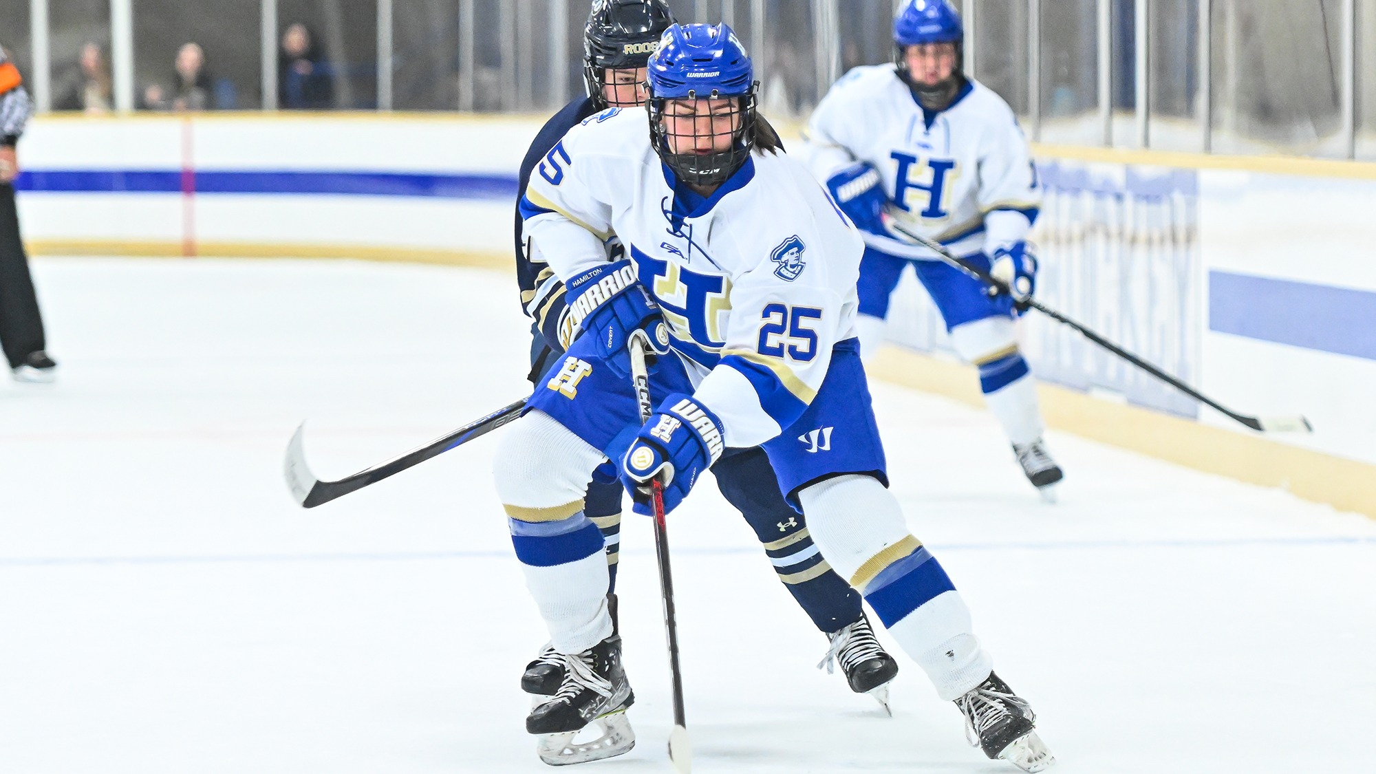 Sarah Myziuk stickhandles the puck through the left faceoff circle in the offensive zone against SUNY Canton