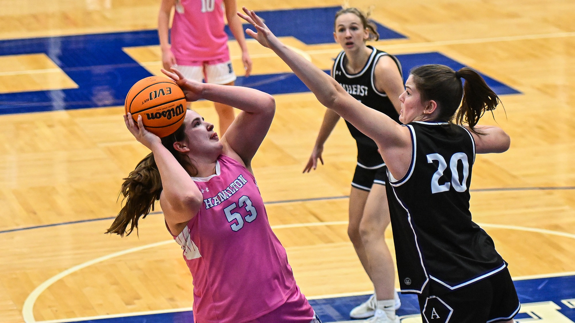 Taylor Lambo puts up a shot in the paint as an Amherst player tried to block it