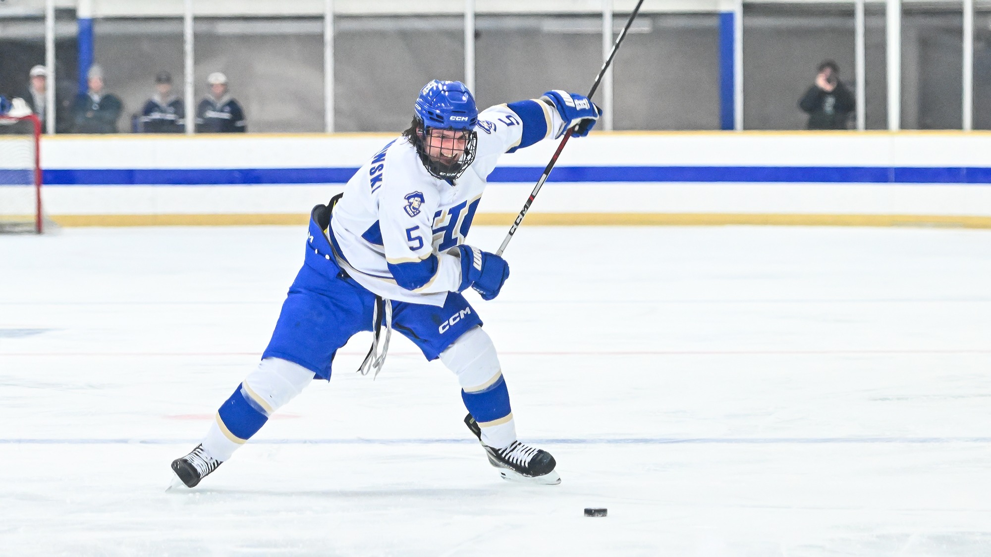 John Wojciechowski winds up for a slap shot in a men's hockey game against Conn. College