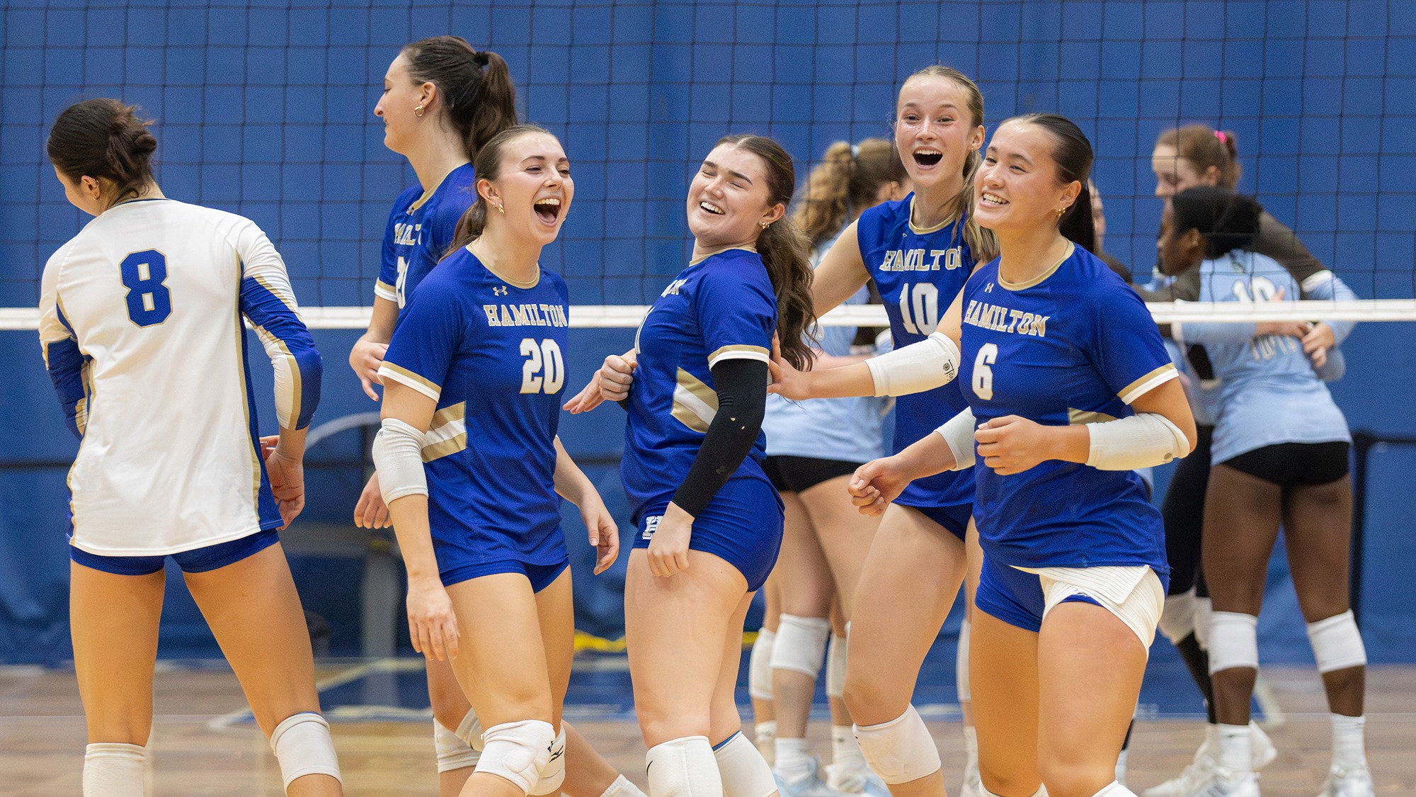 Volleyball players break their huddle right before the start of the Tufts match