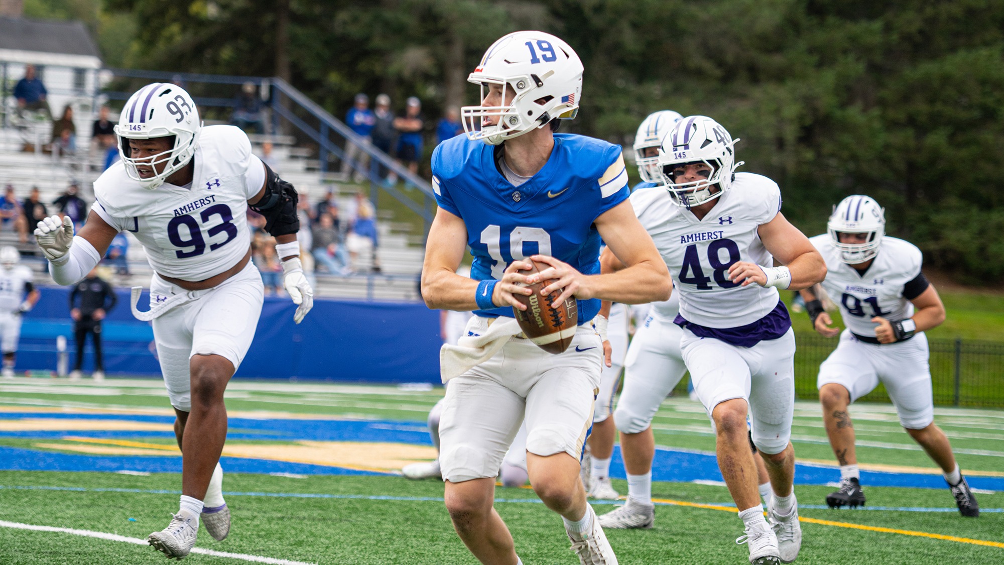 Connor Laverty looks to pass the football on the run against Amherst