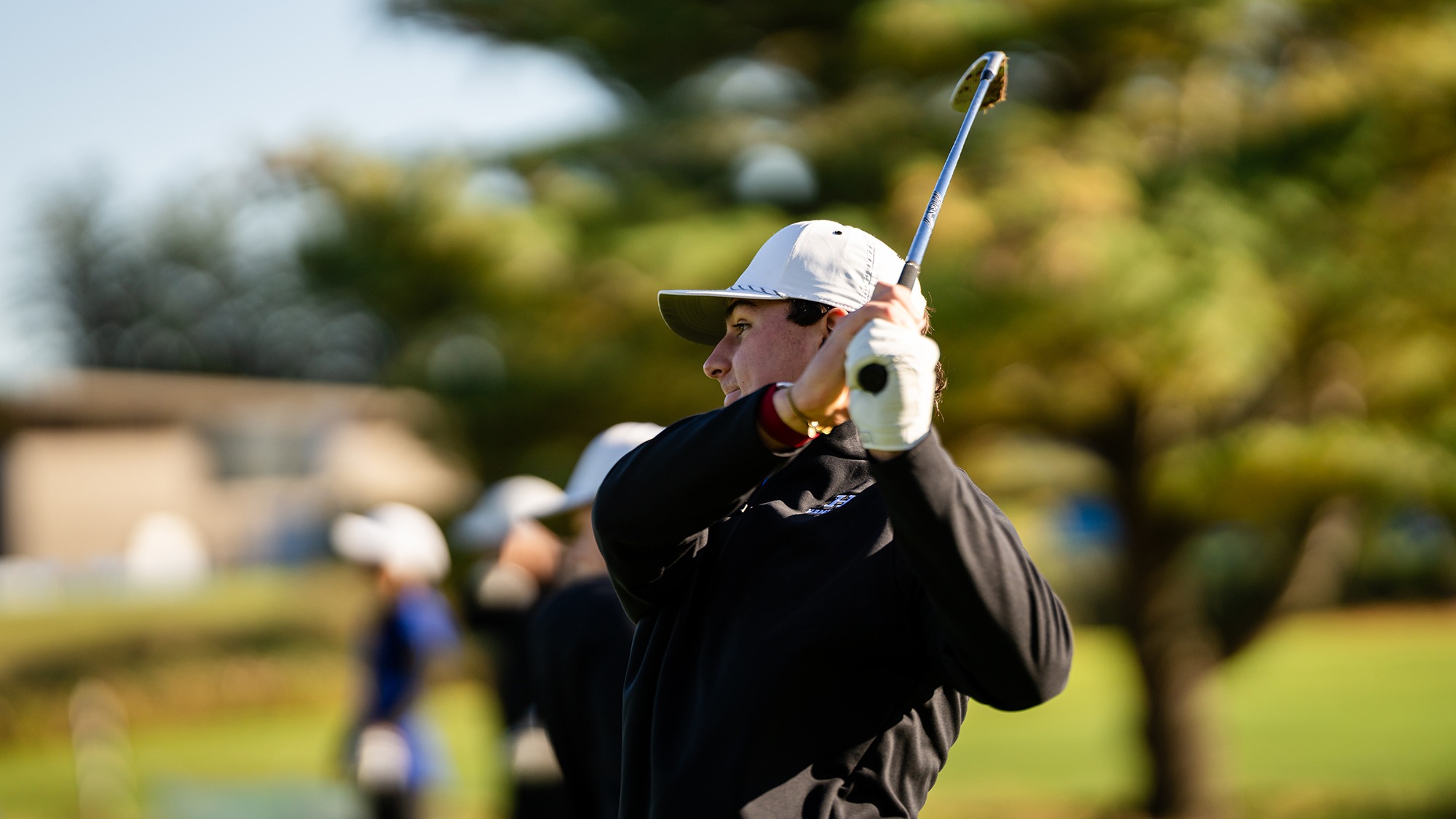 Wyatt Lupo watches his iron shot on the practice range during men's golf practice in the fall of 2026