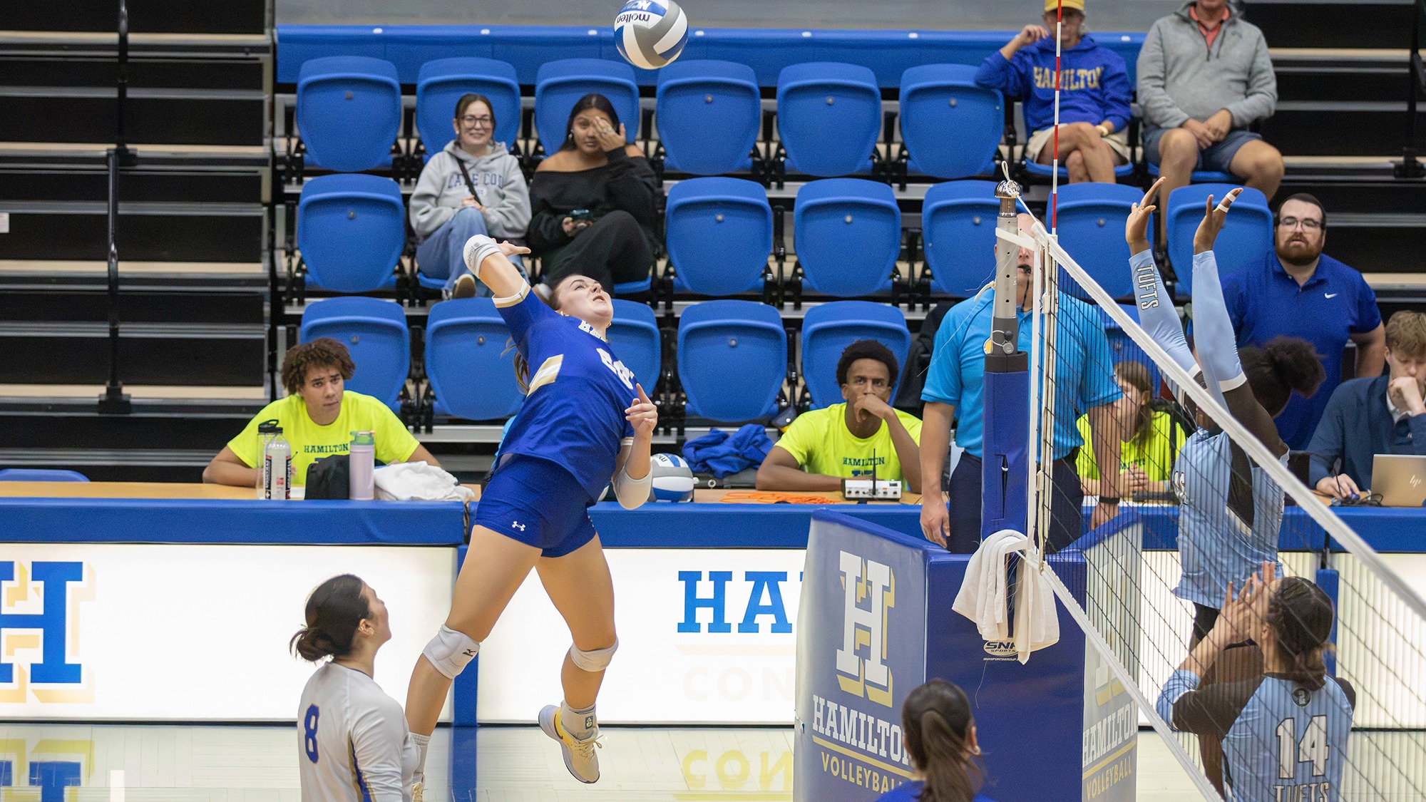 Ayzlinn Trefren jumps up high to spike the volleyball in the Tufts match.
