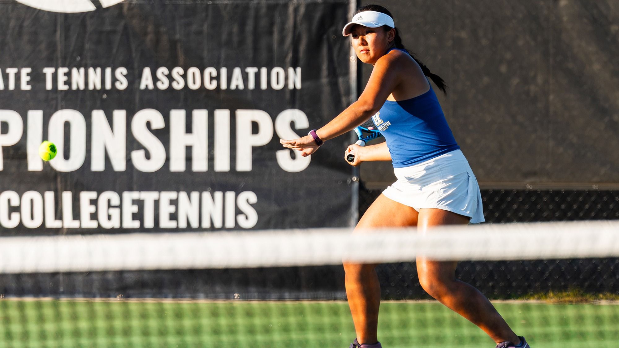 Grace Qian prepares to hit the ball in her ITA Cup women's tennis doubles match