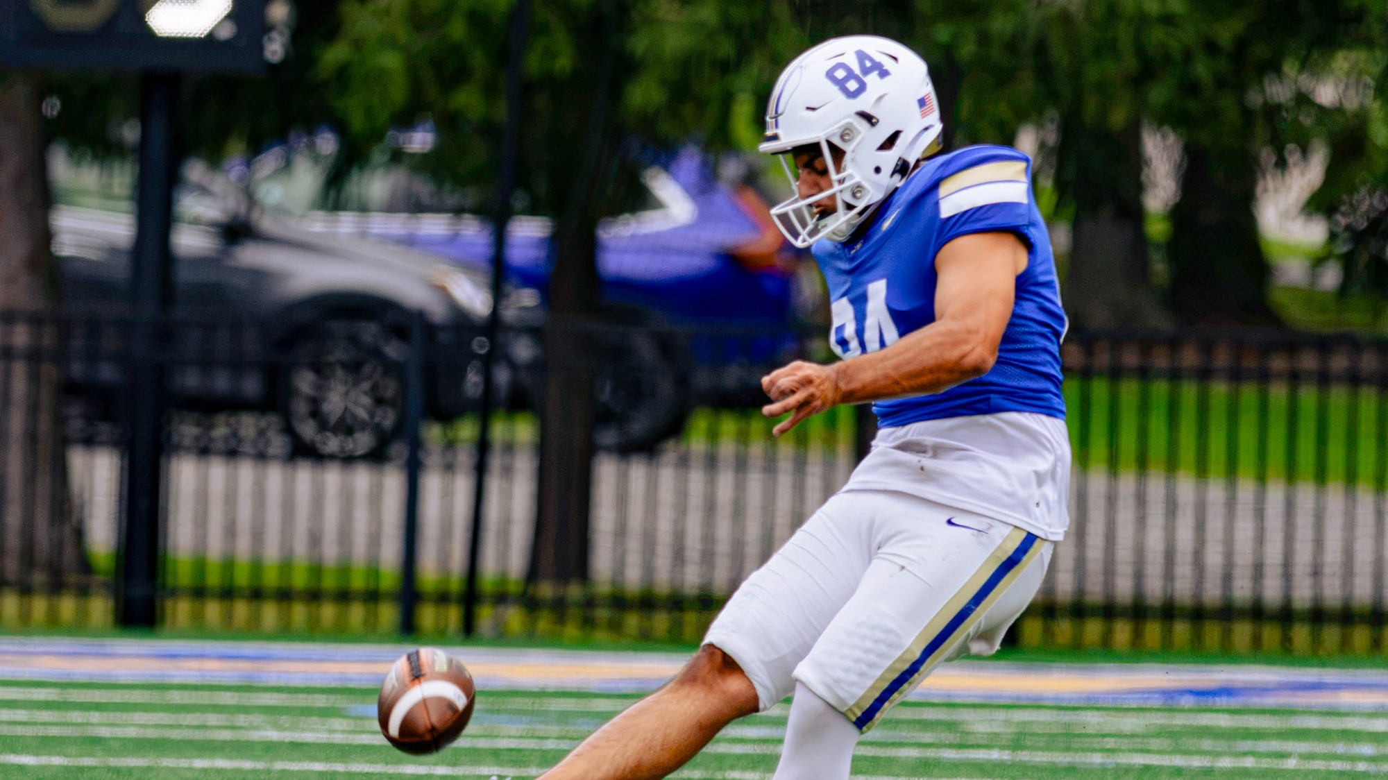 Carmelo Velardo kicks off in a football game against Amherst