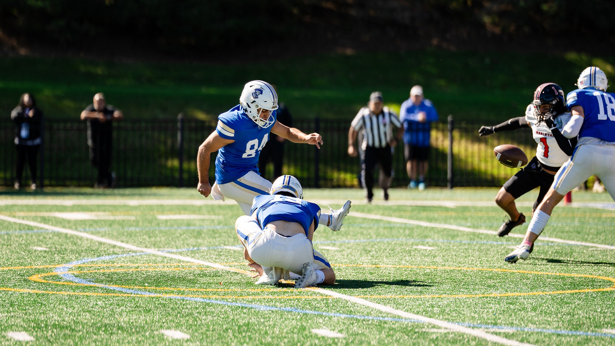Carmelo Velardo kicks an extra point in a football game against Wesleyan