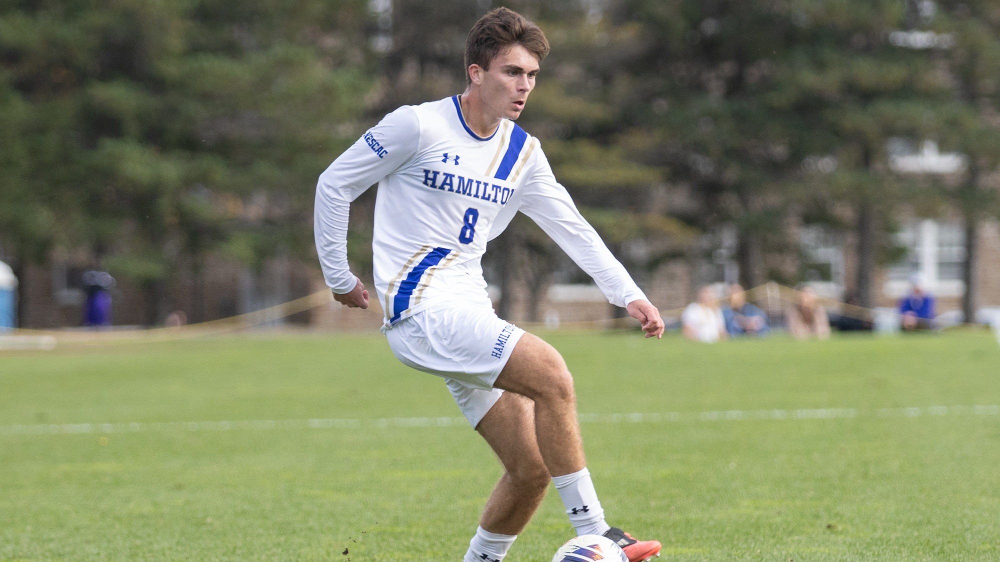 Troy Miller dribbles the soccer ball in Hamilton's offensive zone in a men's match with Amherst