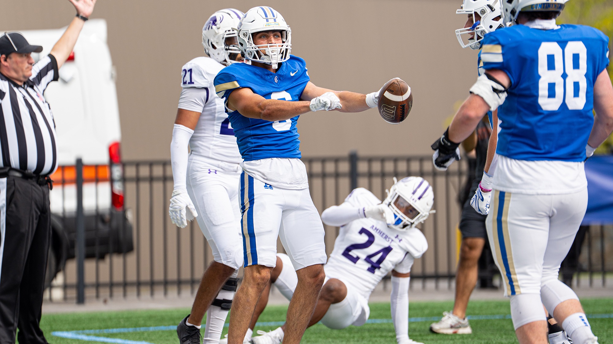Matthew Kearns celebrates a touchdown with a dance in a football game against Amherst
