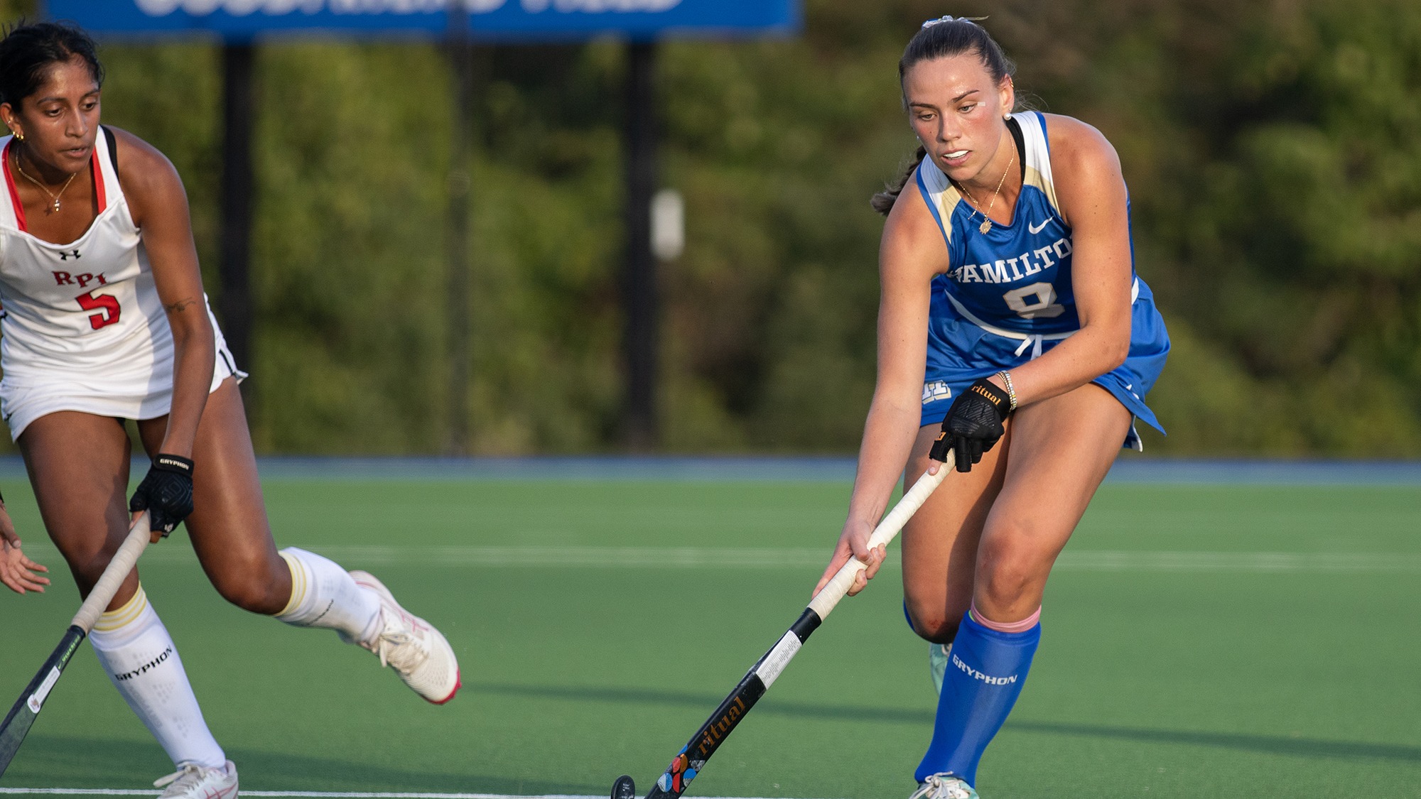 Kenna White stickhandles the field hockey ball up the field against RPI