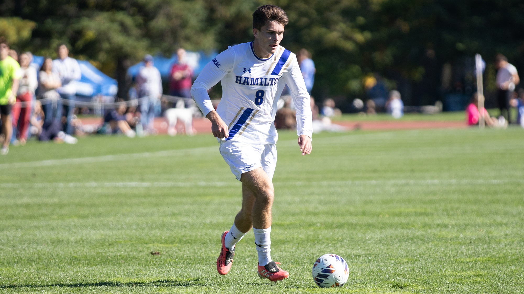 Troy Miller dribbles the soccer ball towards the 18-yard box against Wesleyan