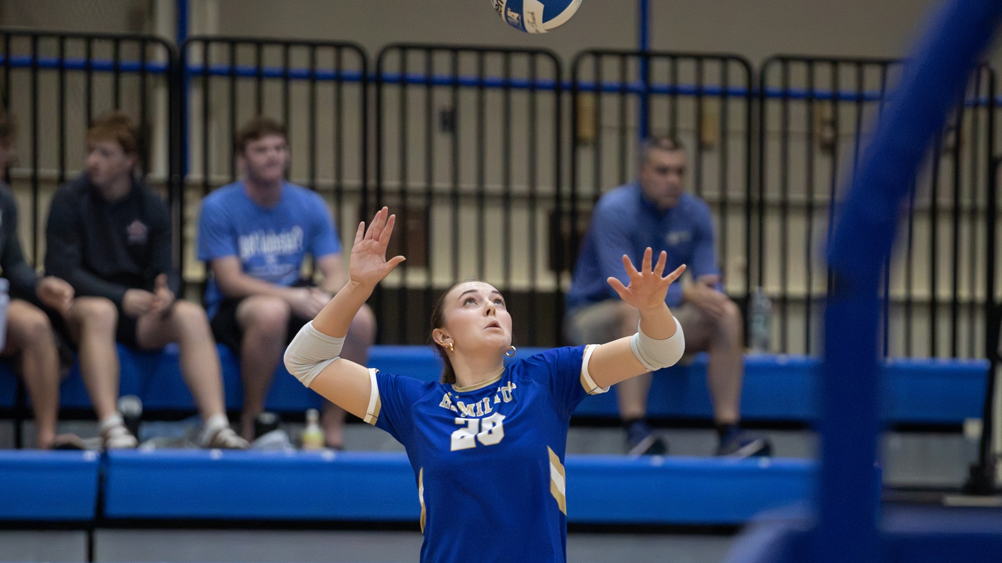 Ayzlinn Trefren serves the volleyball during a match against Tufts