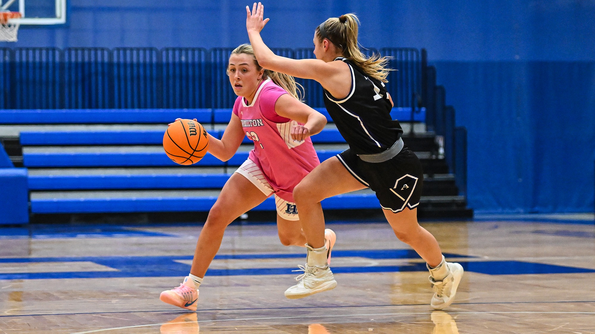 Maggie Kernodle drives with the basketball from the top of the key against Amherst