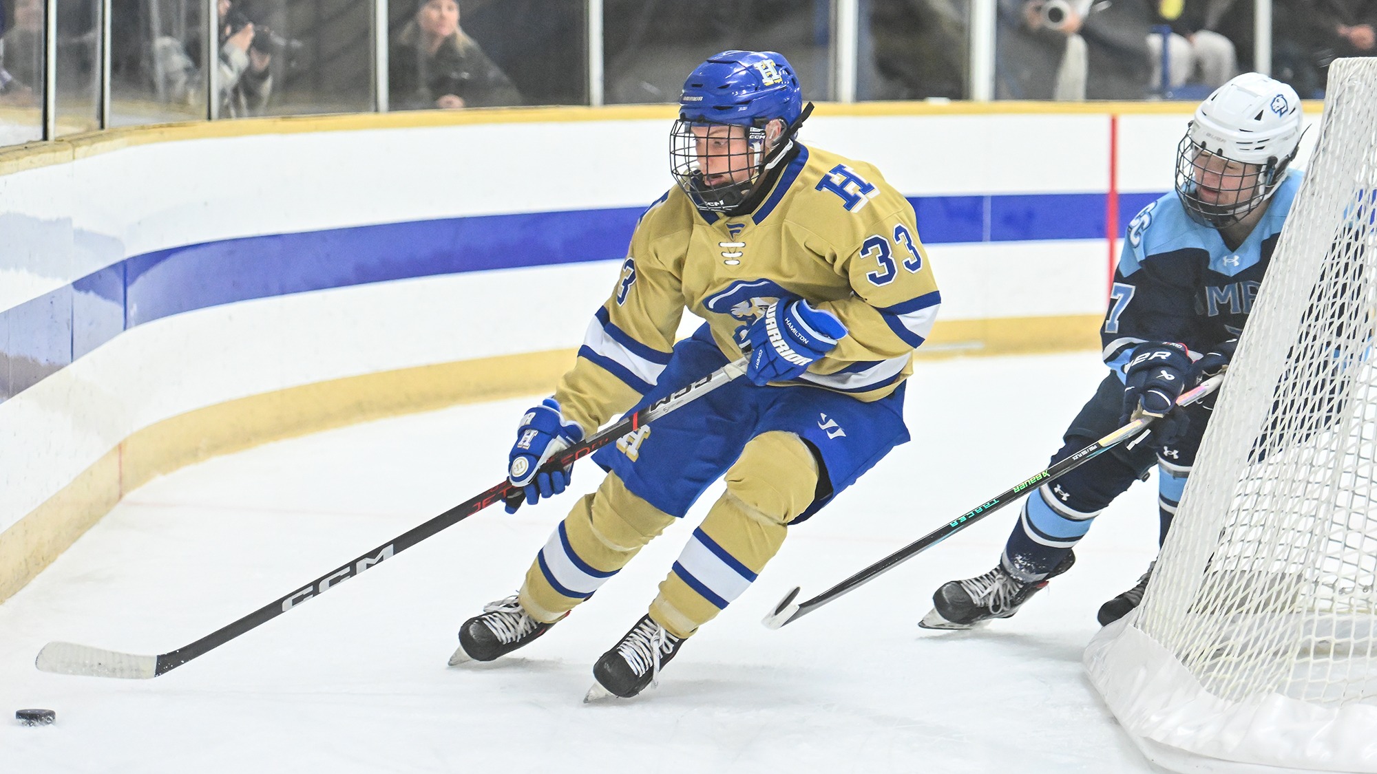 Katie Allen maneuvers with the hockey puck behind the Conn. College goal